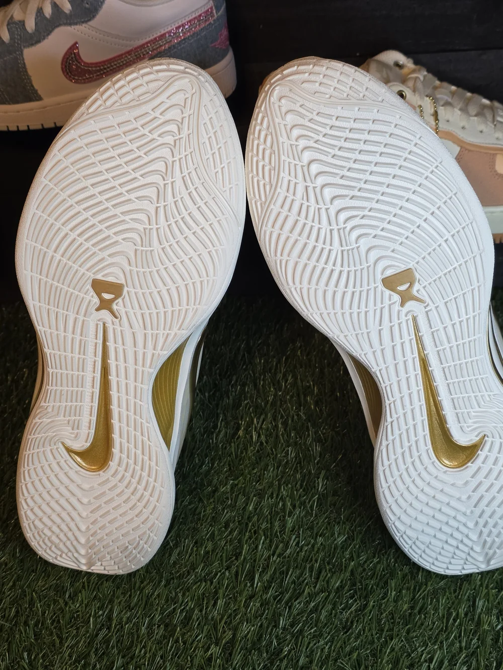Nike Women's White Sneakers with Gold Swoosh